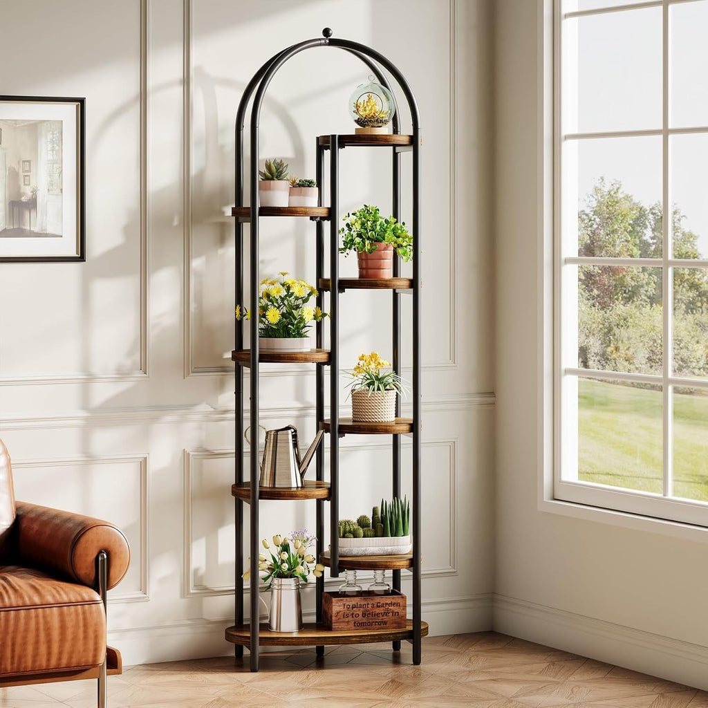 Plant stand styled with plants and decor beside a leather armchair