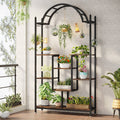 Stowena arched 5 tier plant stand filled with potted and hanging plants