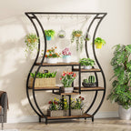 Stowena vase shaped 6 tier plant stand filled with potted and hanging plants