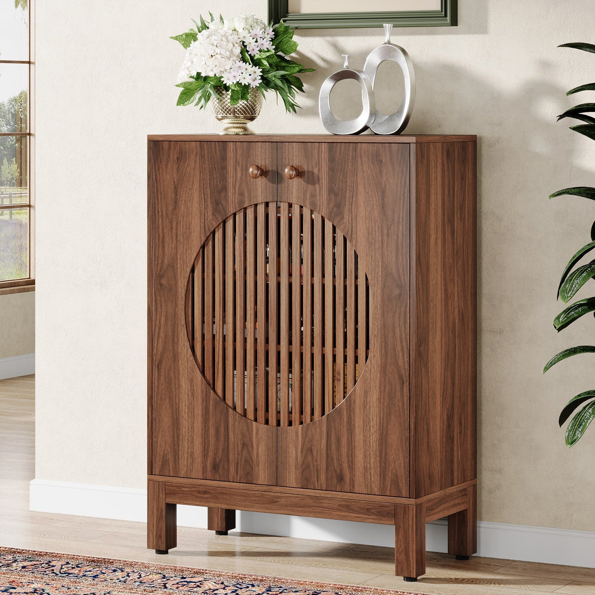 Brown louvered sideboard styled against a wall with vases on top