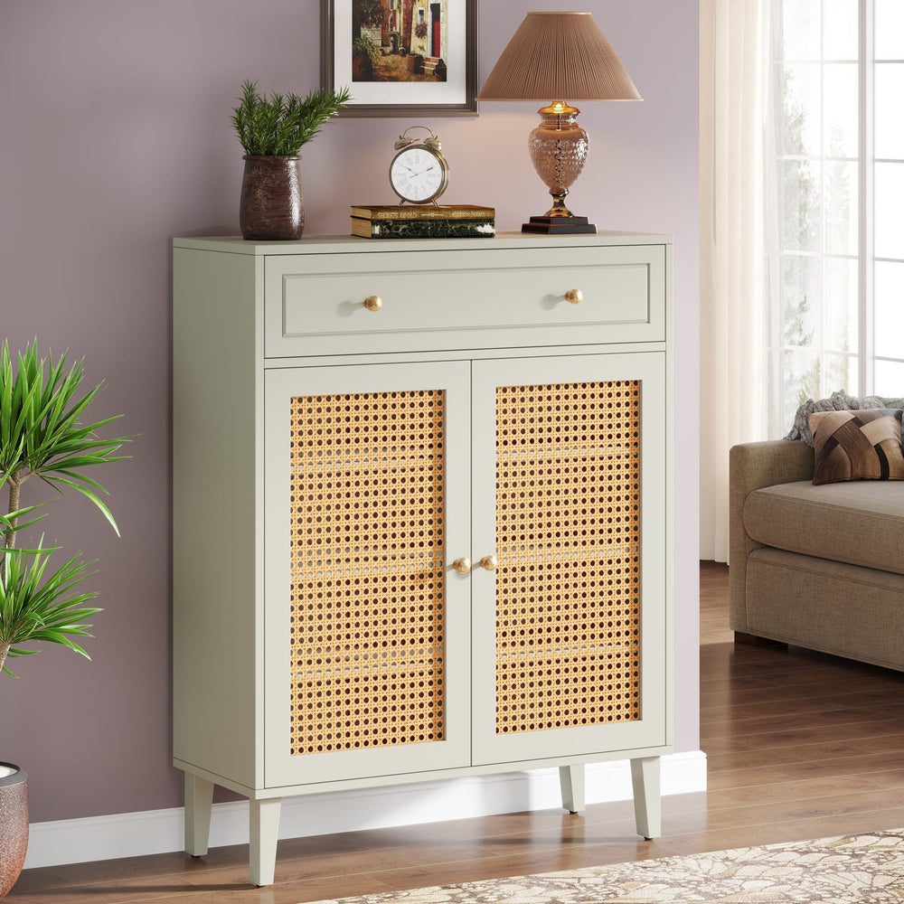 Stowena mint green rattan sideboard cabinet with drawer beside a sofa and floor plant