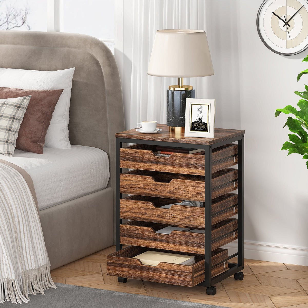 Five drawer rolling chest used as a bedside table with the lowest drawer open