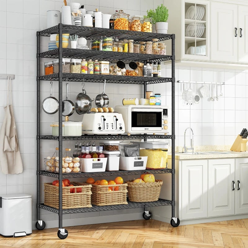 Black wire shelving unit in a kitchen holding a microwave, baskets, and pantry items
