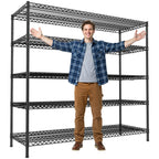Black 5 tier wire shelving unit on a white background with a person standing beside it, arms spread to show the width