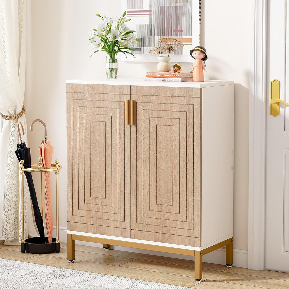 White and natural shoe cabinet with gold legs holding flowers by the front door