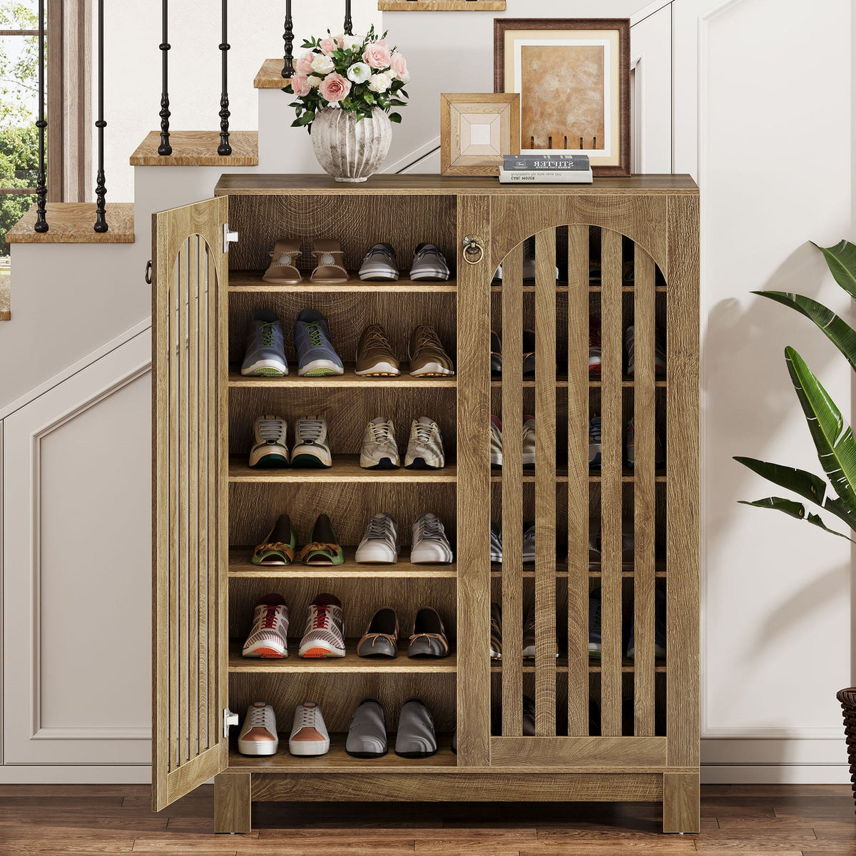Shoe cabinet with one door open showing six tiers of shoes