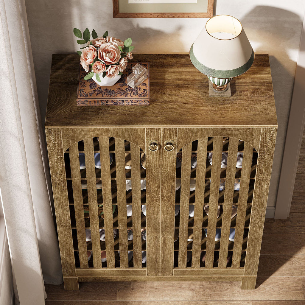 Top view of the shoe cabinet with a lamp and flowers