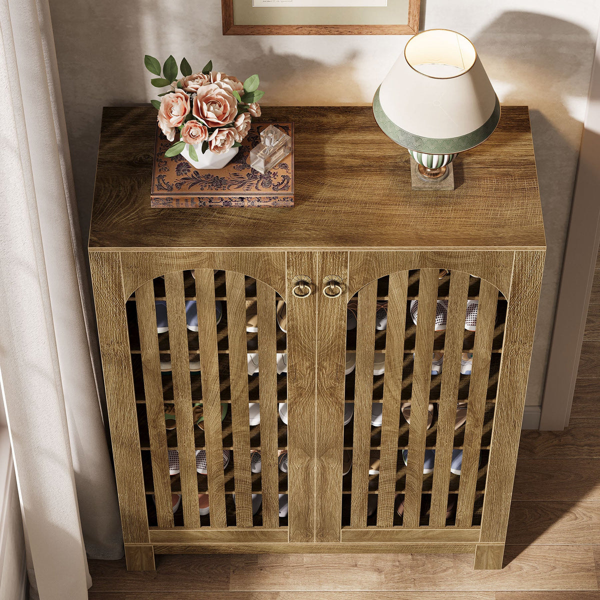Top view of the shoe cabinet with a lamp and flowers