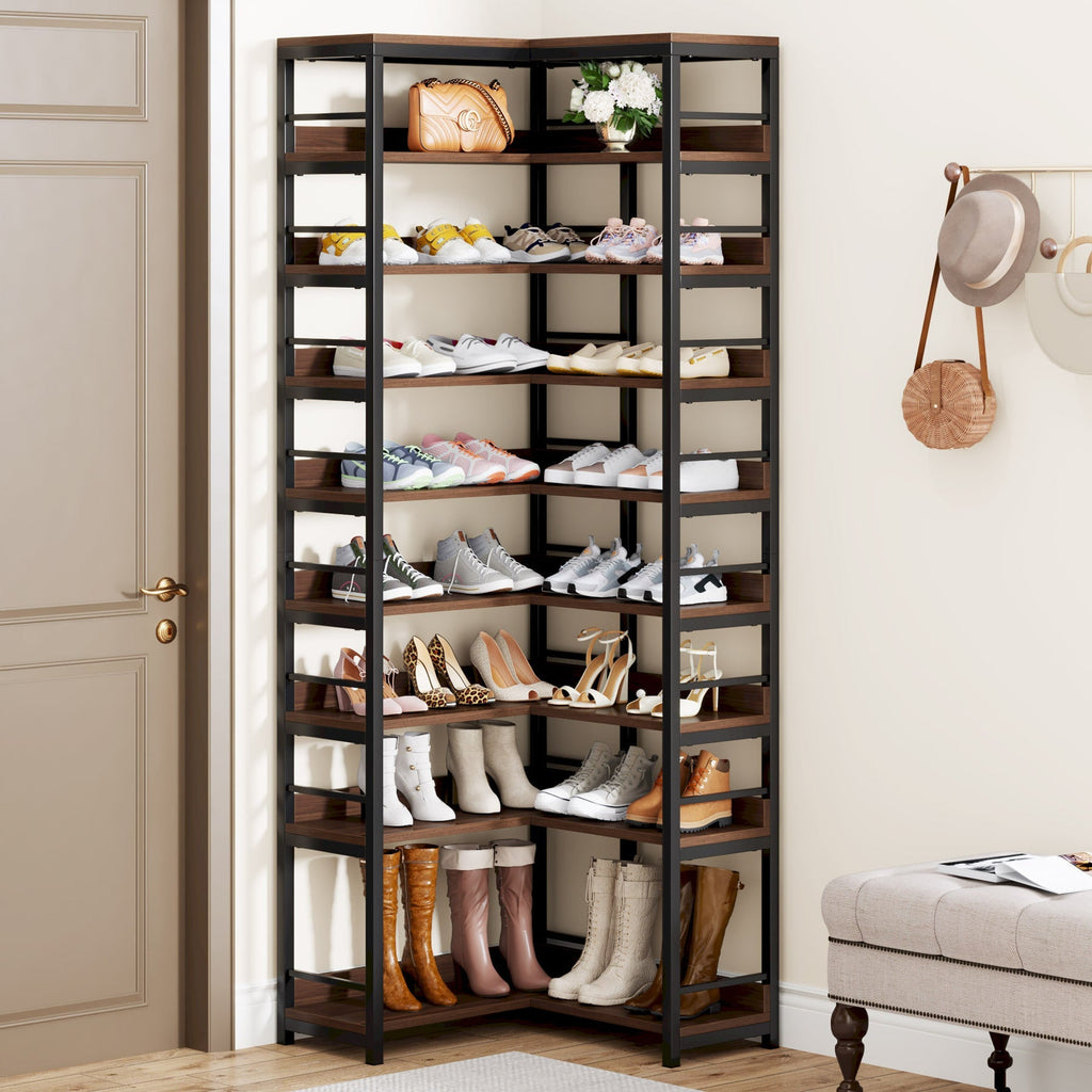 Rustic brown nine tier corner shoe rack filled with shoes and boots beside a front door