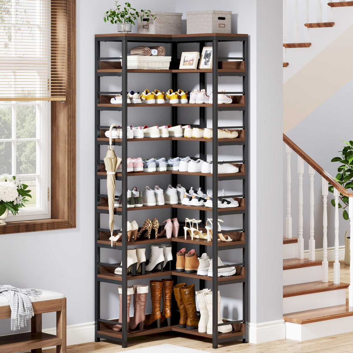 Nine tier corner rack tucked beside a staircase holding a full household of shoes