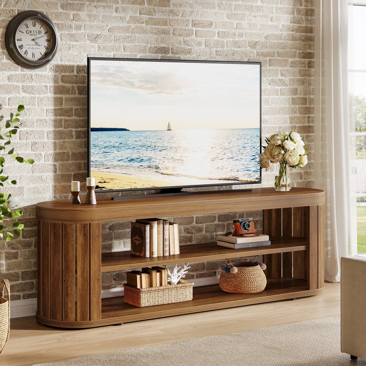 Stowena 47.2 inch TV stand in brown with a TV and decor against a brick wall