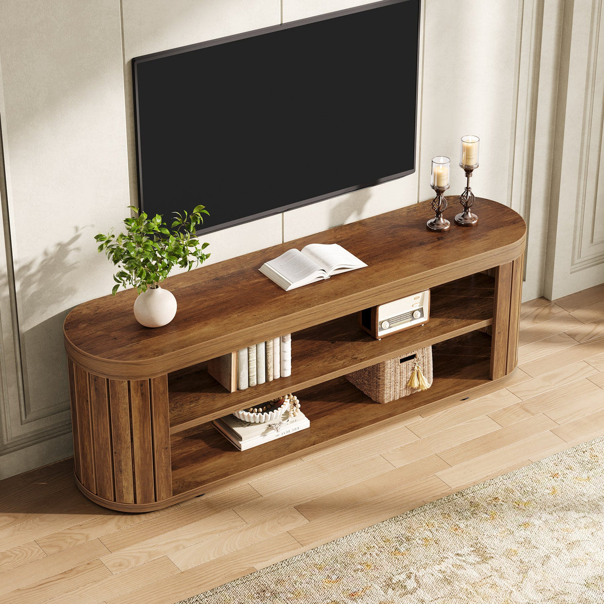 Brown 2 tier media console with a large TV and candles