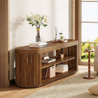 Oval slatted TV stand styled with flowers and books in a bright room