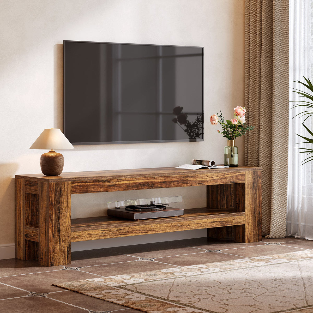 Two tier rustic TV stand with a movie on screen, lamp and flowers beside a window