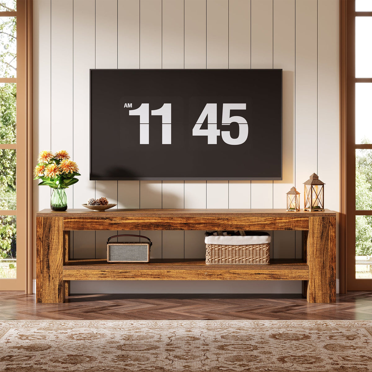 Low bench style TV stand under a large wall TV with baskets on the shelf