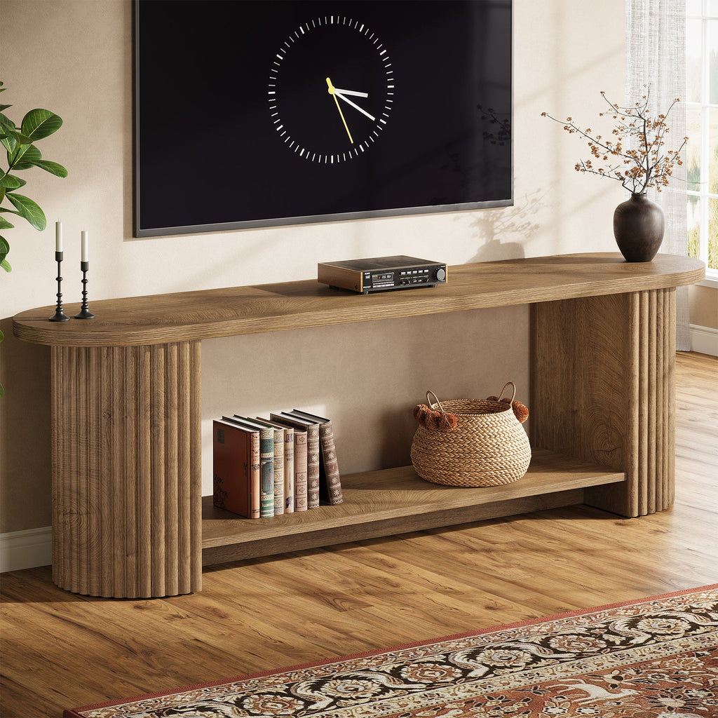 Stowena 63 inch fluted TV stand in wood color with a clock and books in a living room