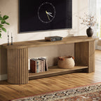 Stowena 63 inch fluted TV stand in wood color with a clock and books in a living room