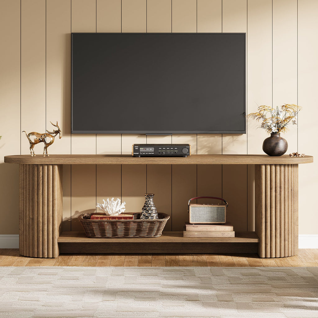 Oval fluted media console with a large TV and baskets on the shelf