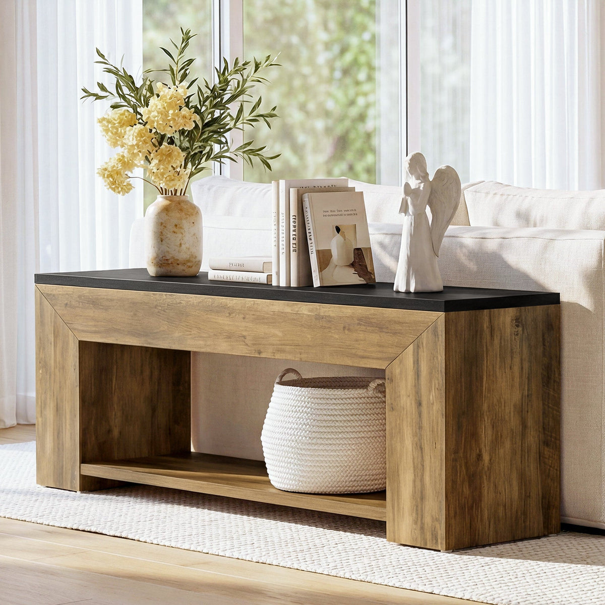 Long low TV console styled as a sofa table with plants and books