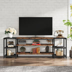 Stowena 78 inch rustic and black TV stand holding a large TV in a living room