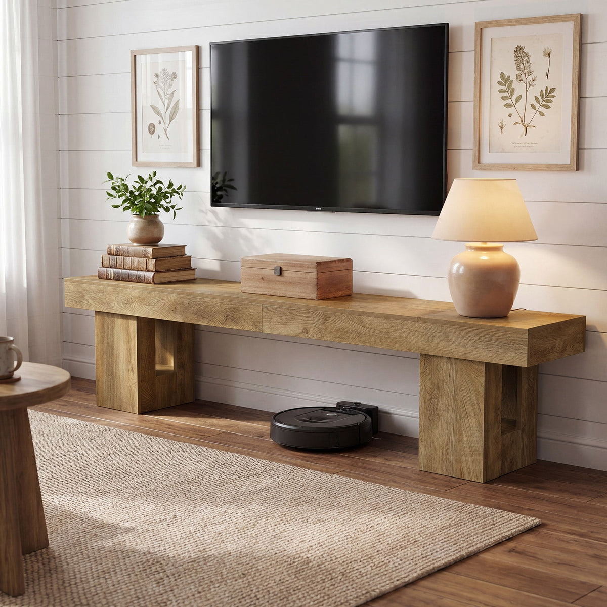 Stowena 83 inch low TV stand in natural oak with a large TV against a shiplap wall