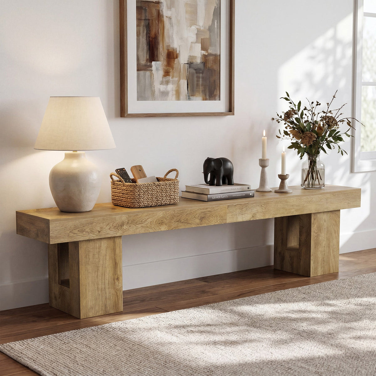 Natural oak console styled with a lamp, basket and flowers along a wide wall