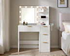 White fluted vanity desk with LED mirror beside a bed, charging station on the side