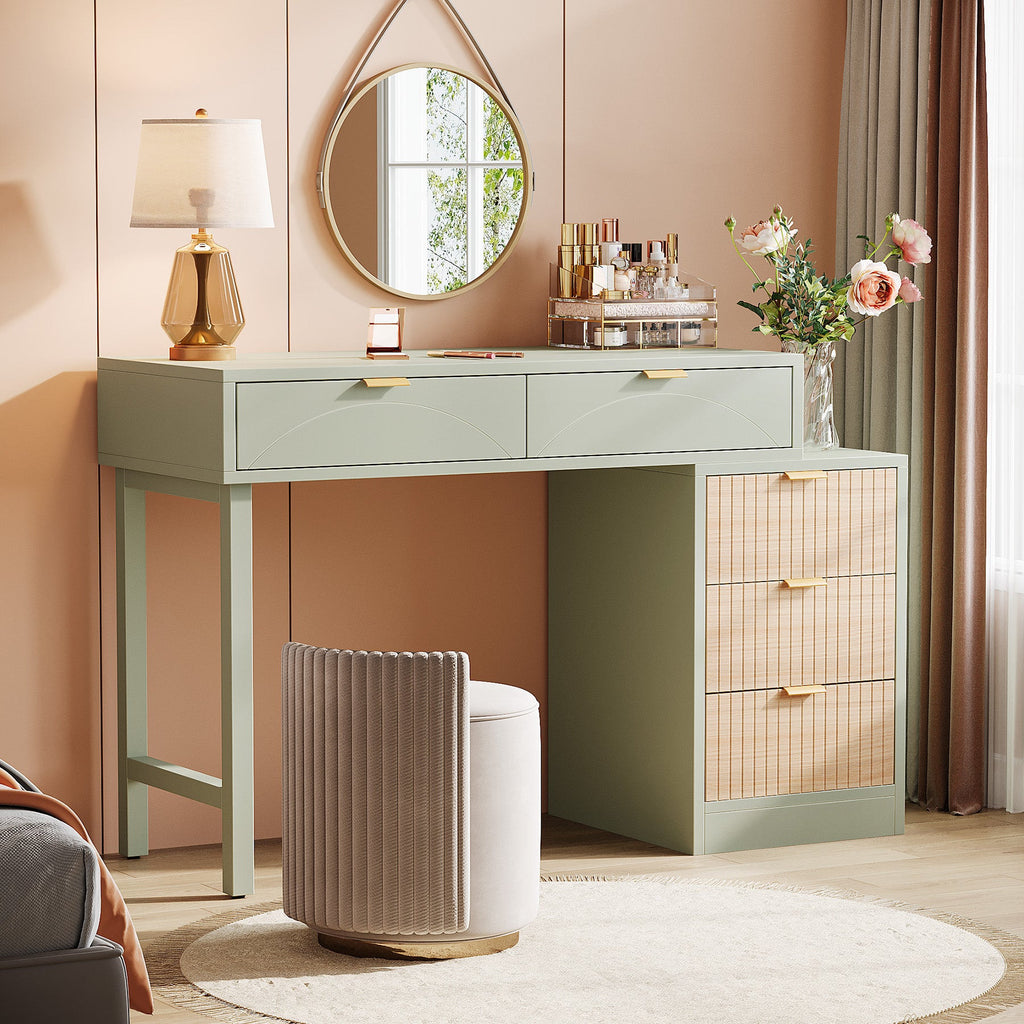 Vanity used as a writing desk with a table lamp and reading corner