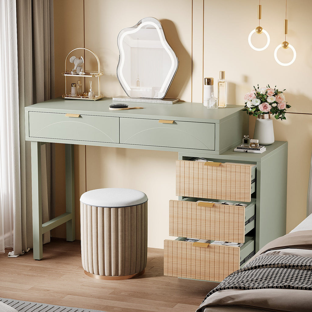 Three cabinet drawers open showing deep storage on the mint green vanity